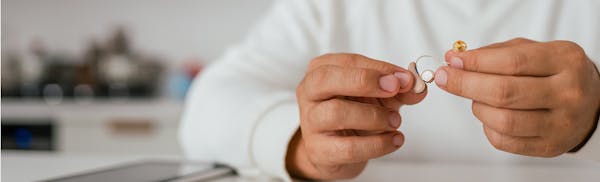 doctor holding hearing aids