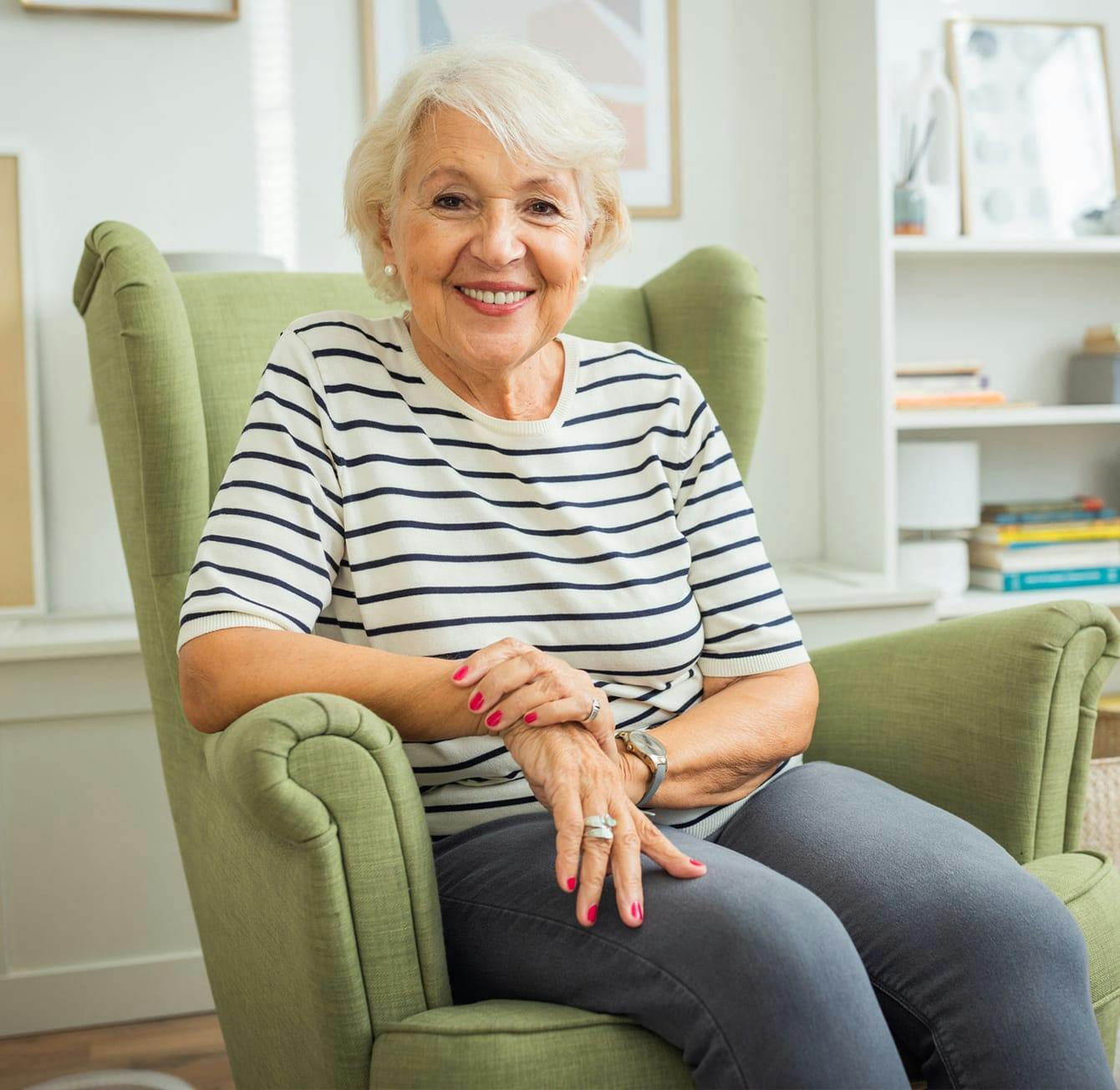older woman sitting in a green chair