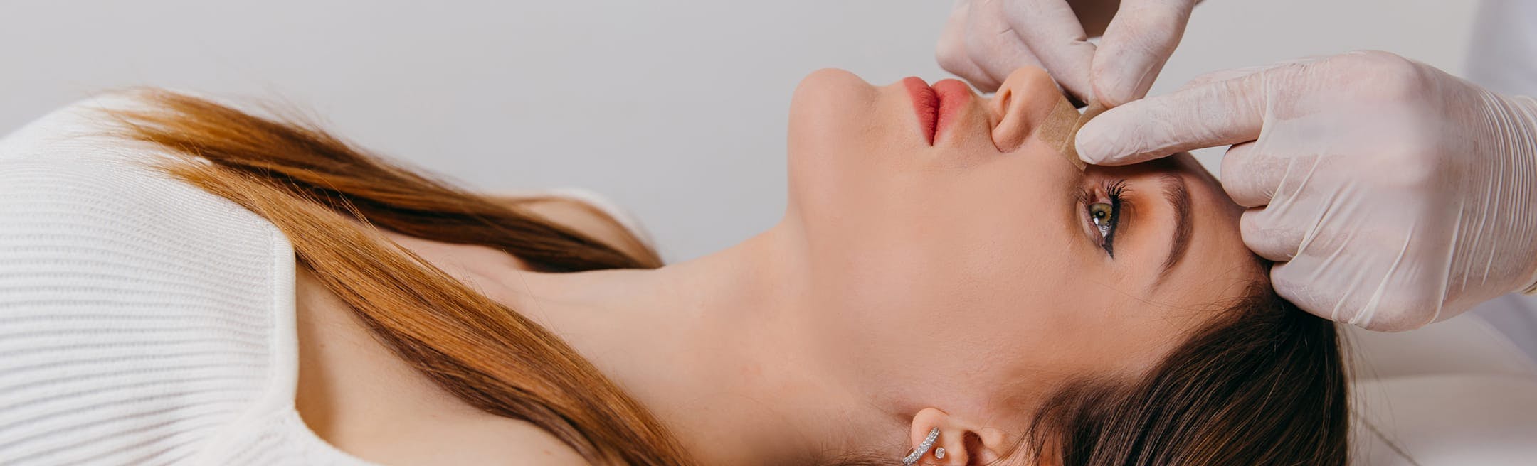 woman getting her nose taped