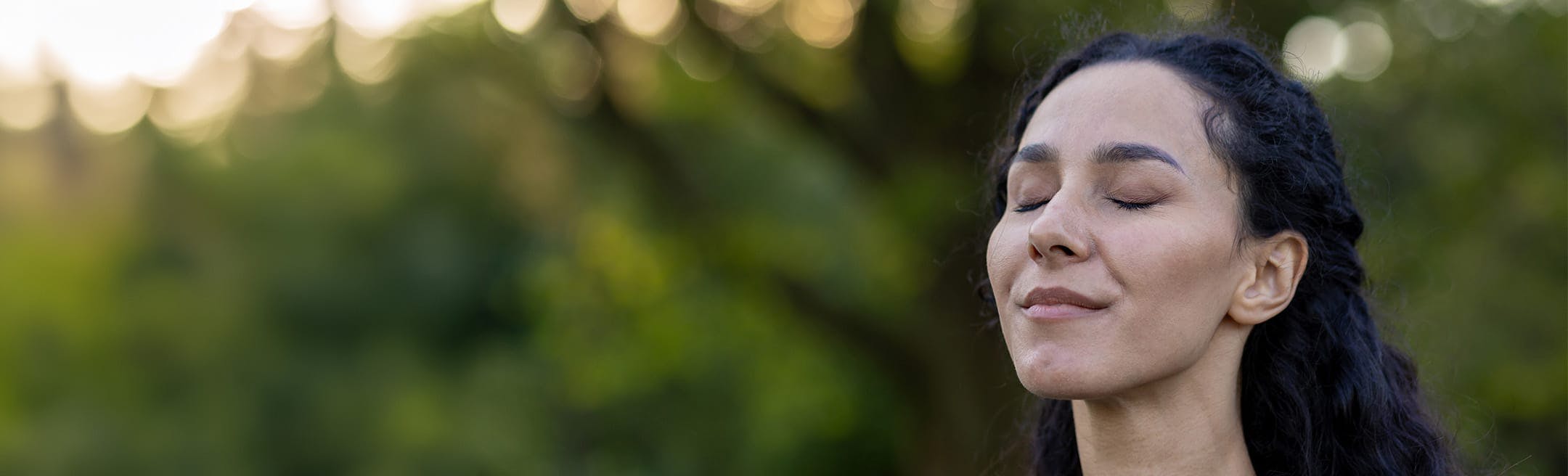 woman with her eyes closed outside