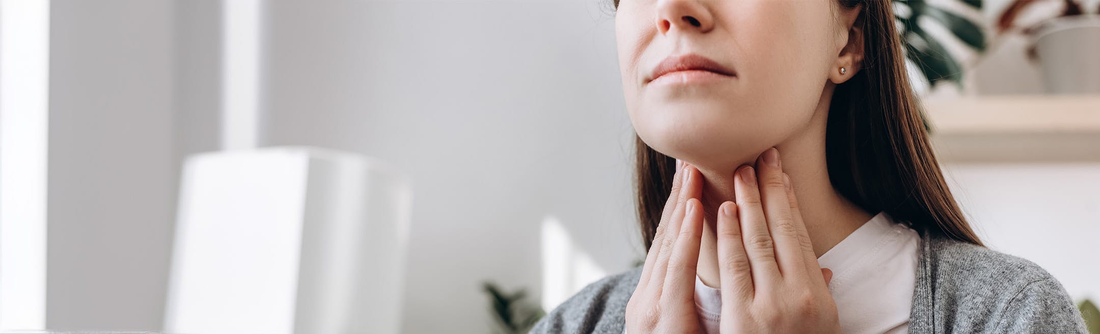 woman touching her throat