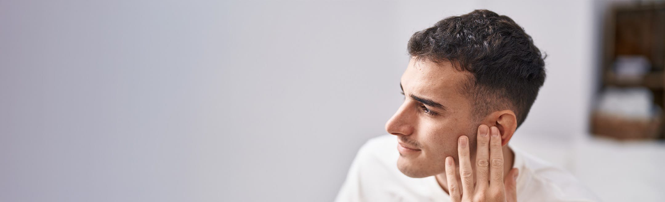 man touching his ear