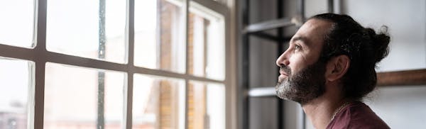 man looking out a window