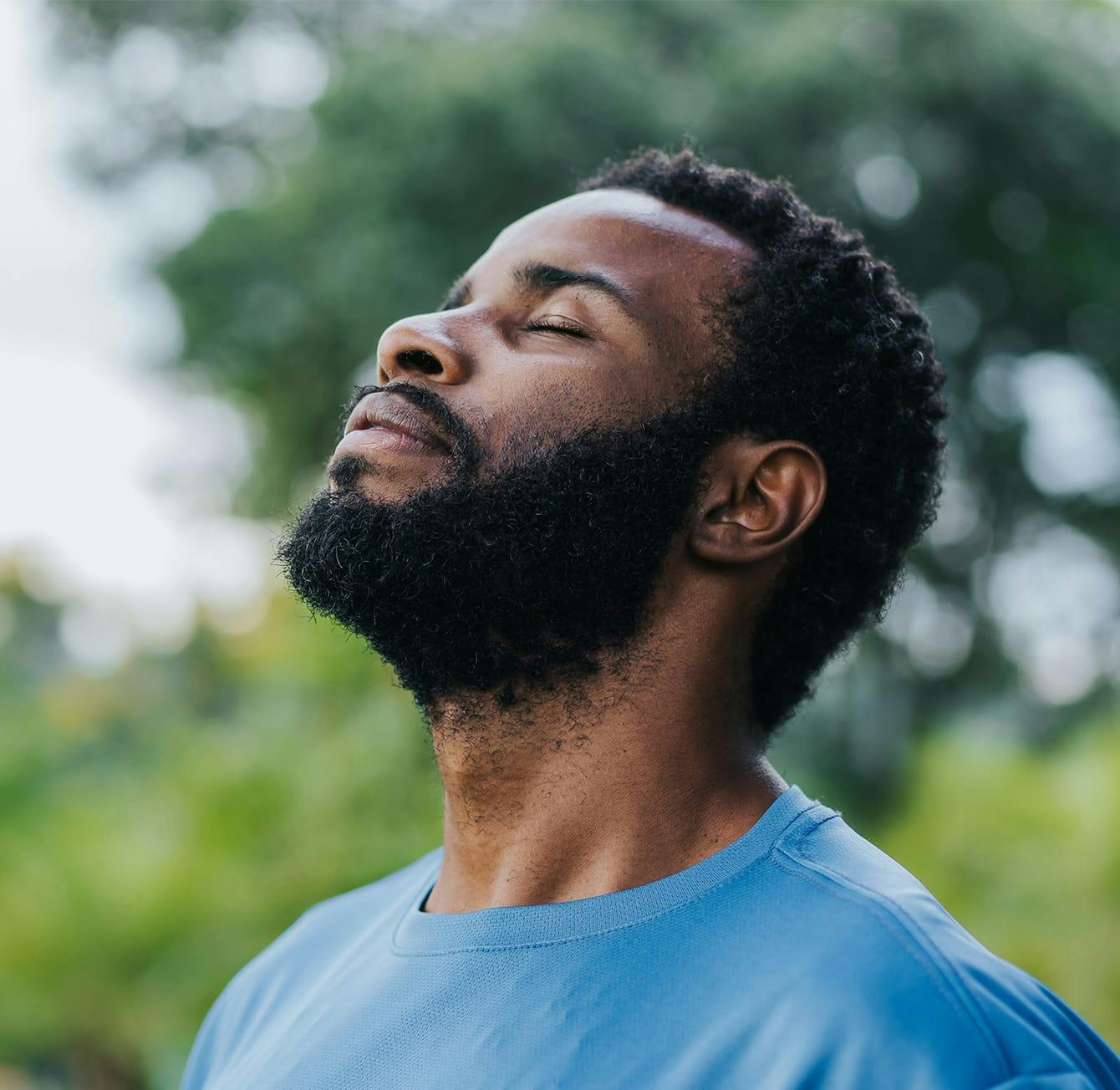 man's face tilted upwards with his eyes closed