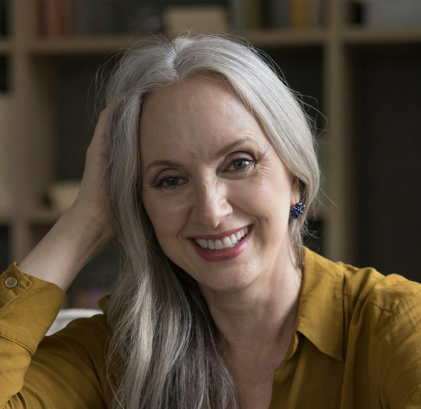 woman with long grey hair smiling