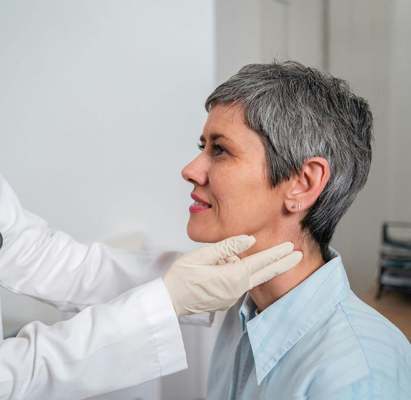 doctor checking a patient's neck