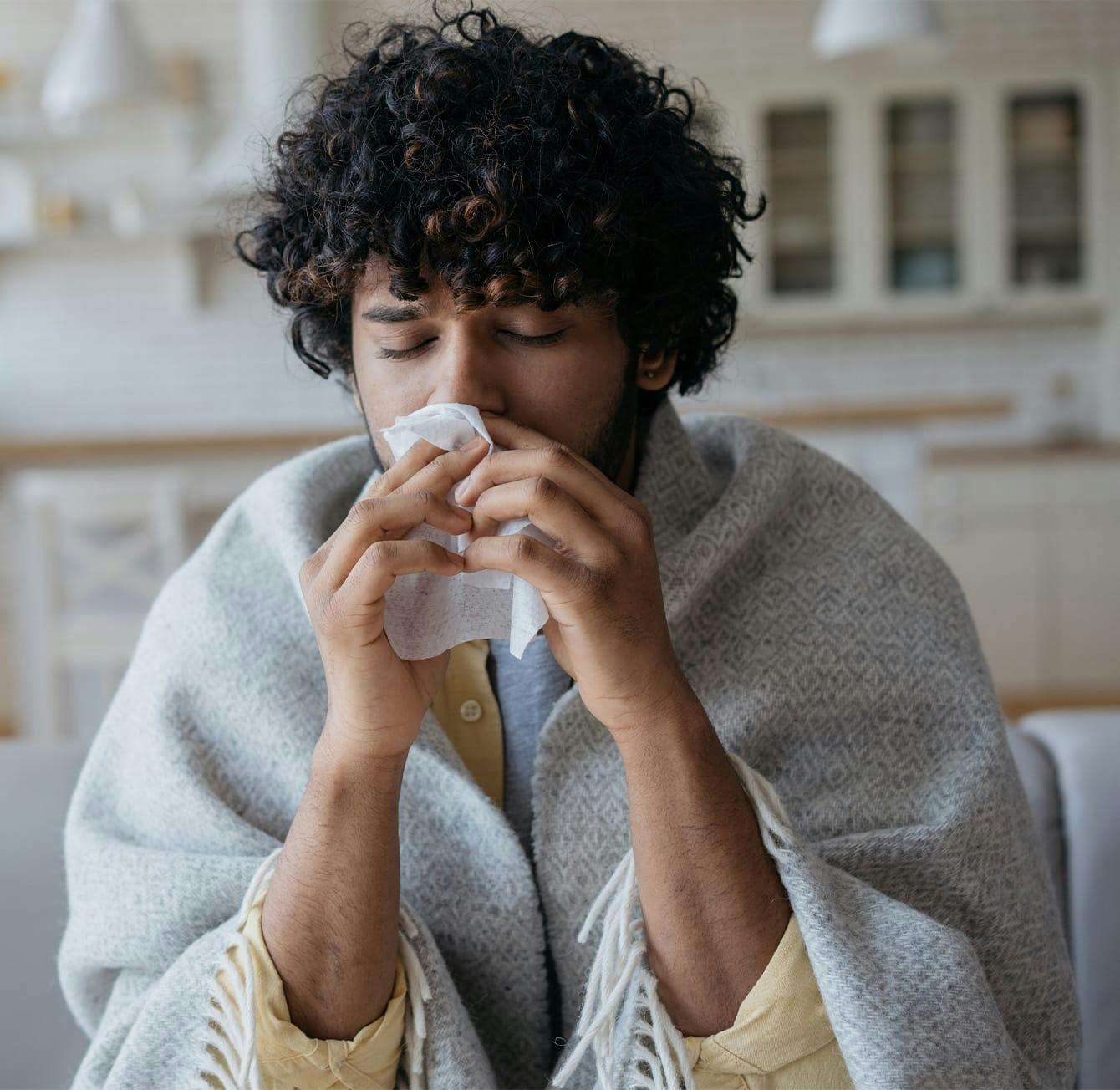 man blowing his nose
