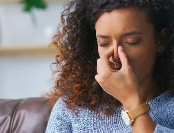 Woman pinching her nose