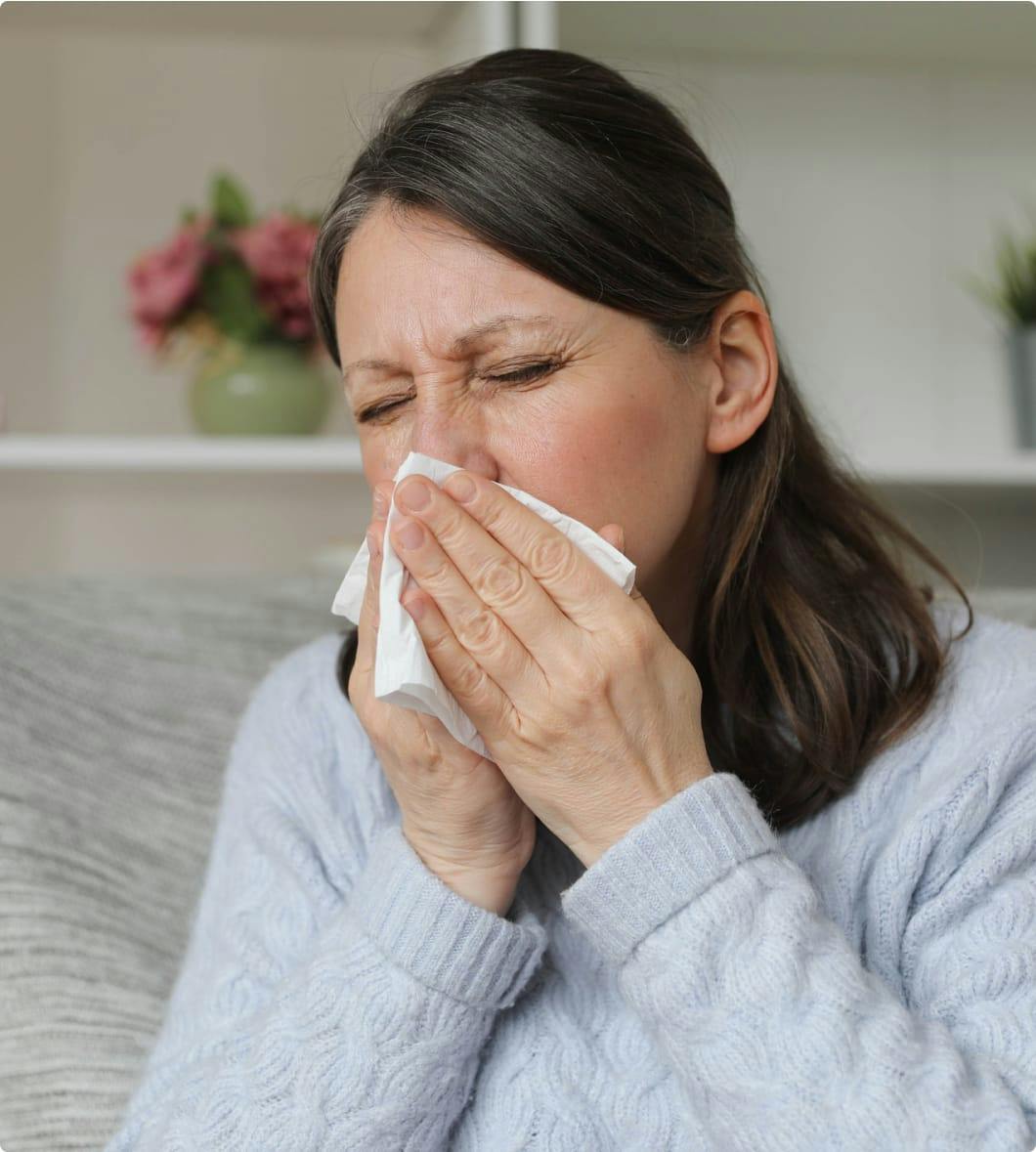 Woman blowing her nose