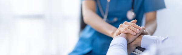 doctor holding patient's hands