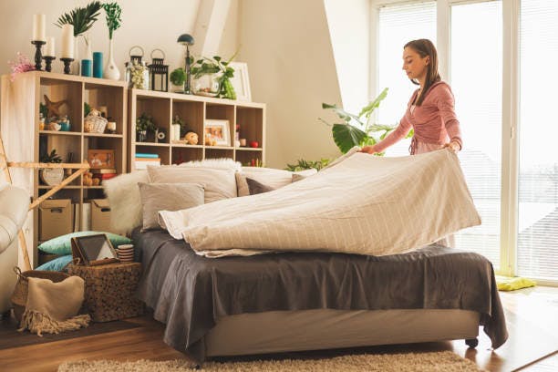 Woman Cleaning Her Bedroom