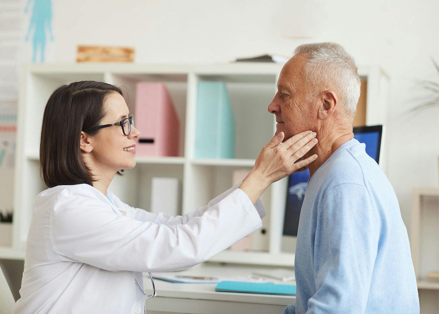 doctor checking patient's neck area