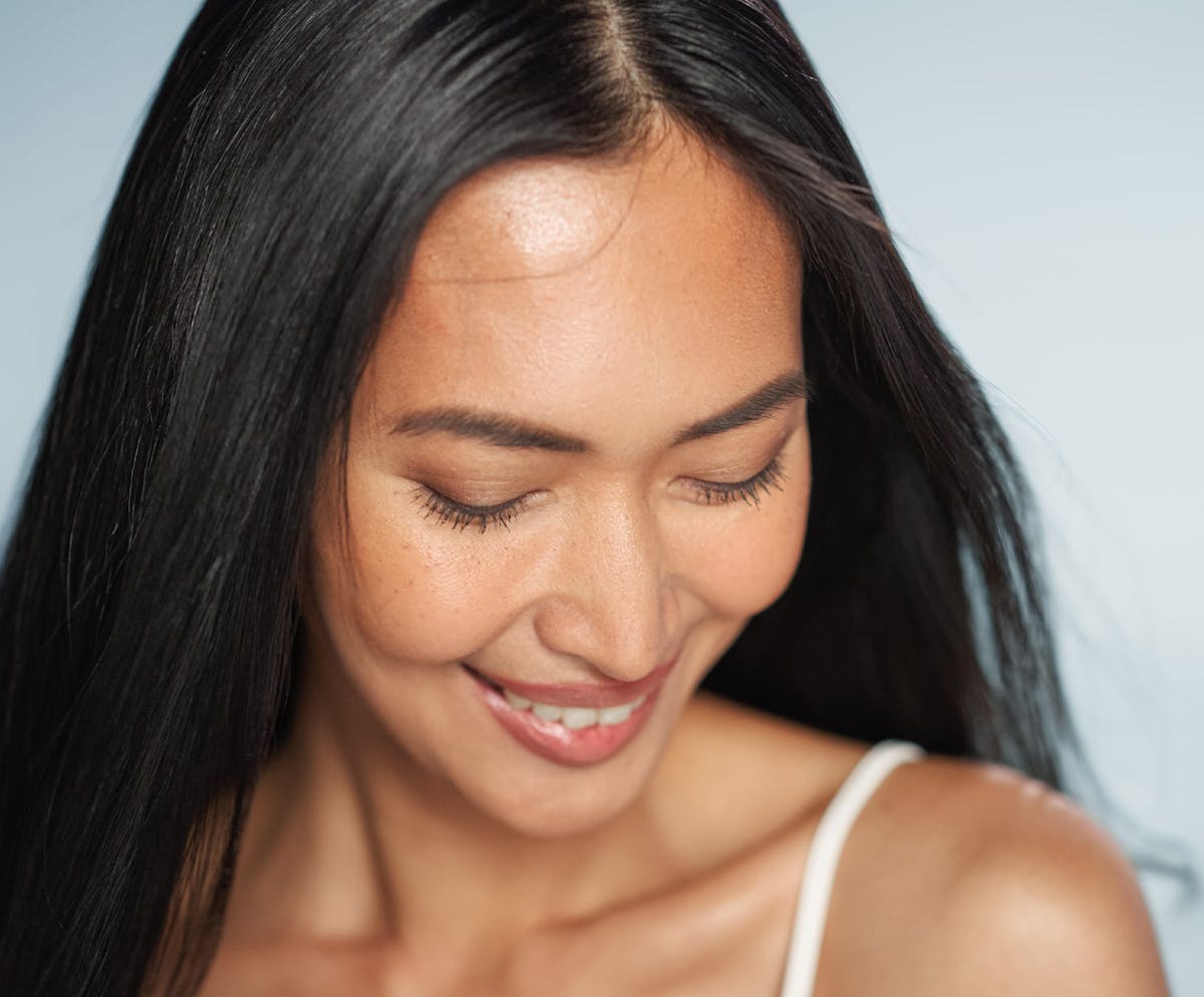 Woman smiling and glancing down