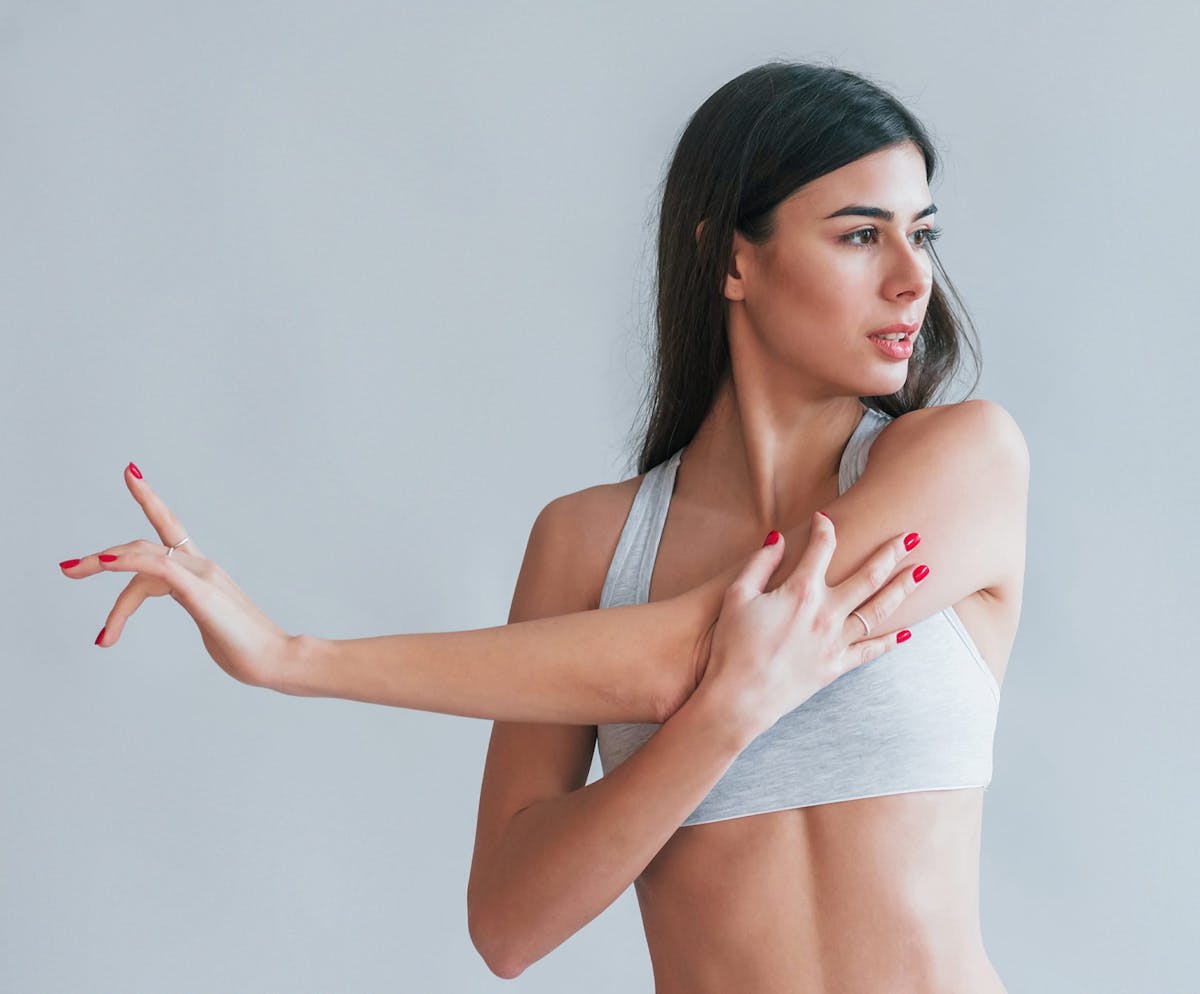 Woman stretching in white top