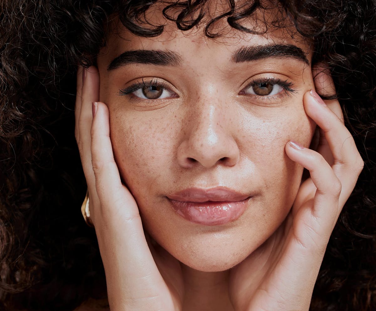 Woman framing face with hands