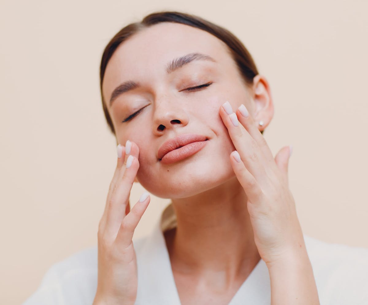 Woman touching cheeks