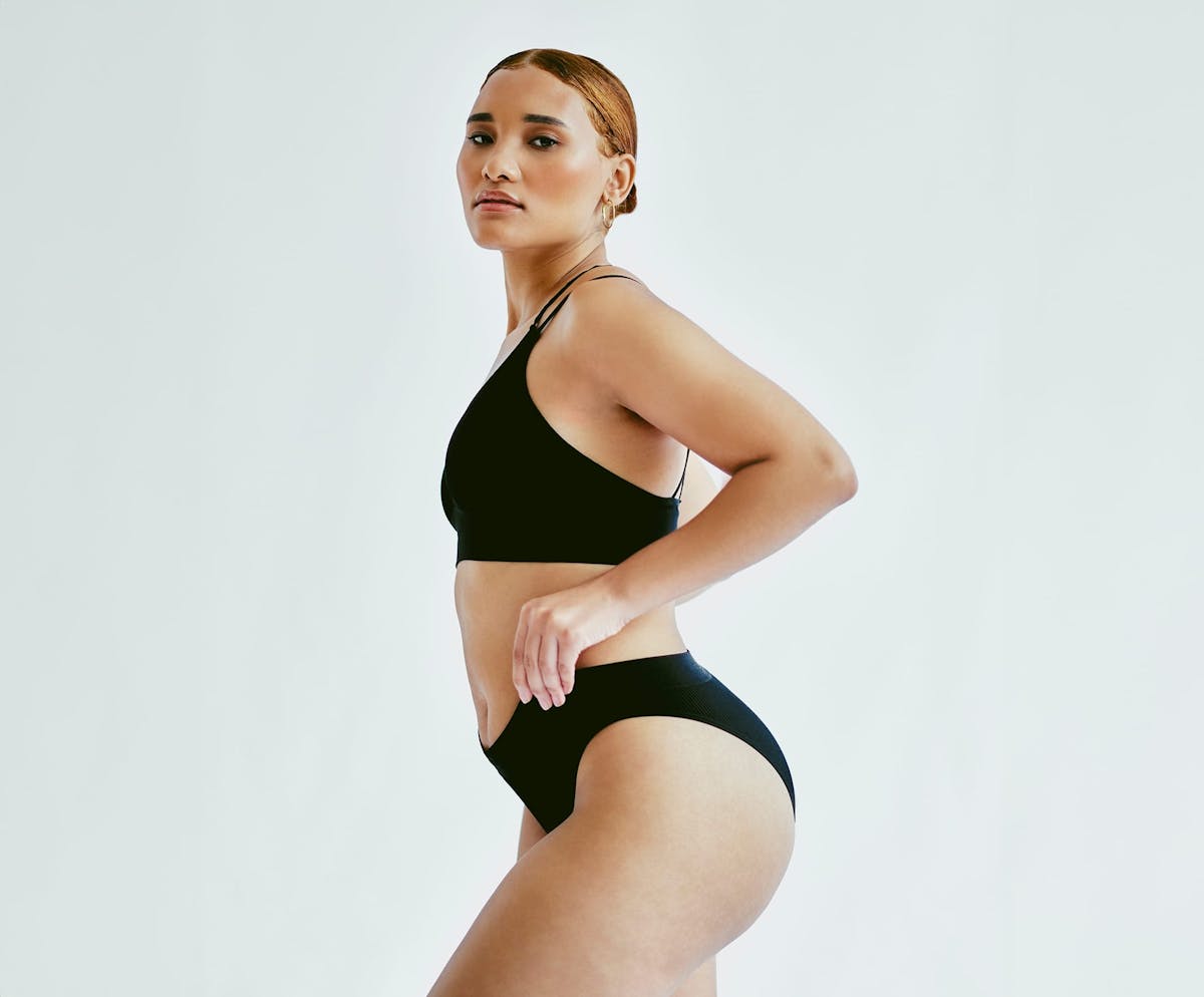 Woman posing in black undergarments