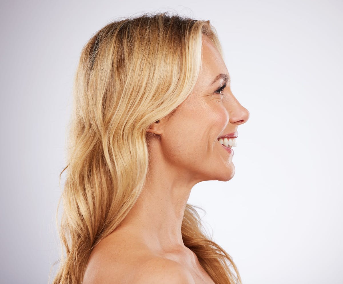 Blonde woman smiling in profile