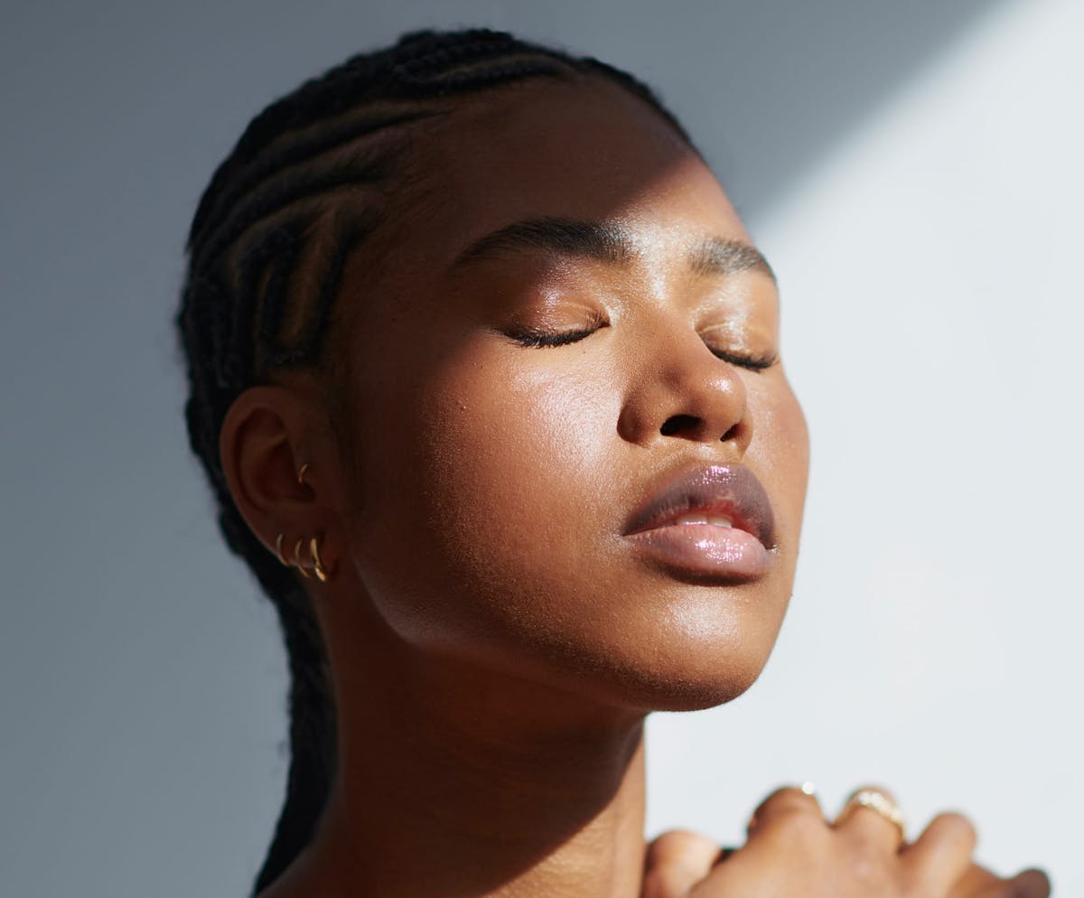 Woman closing eyes in the shade