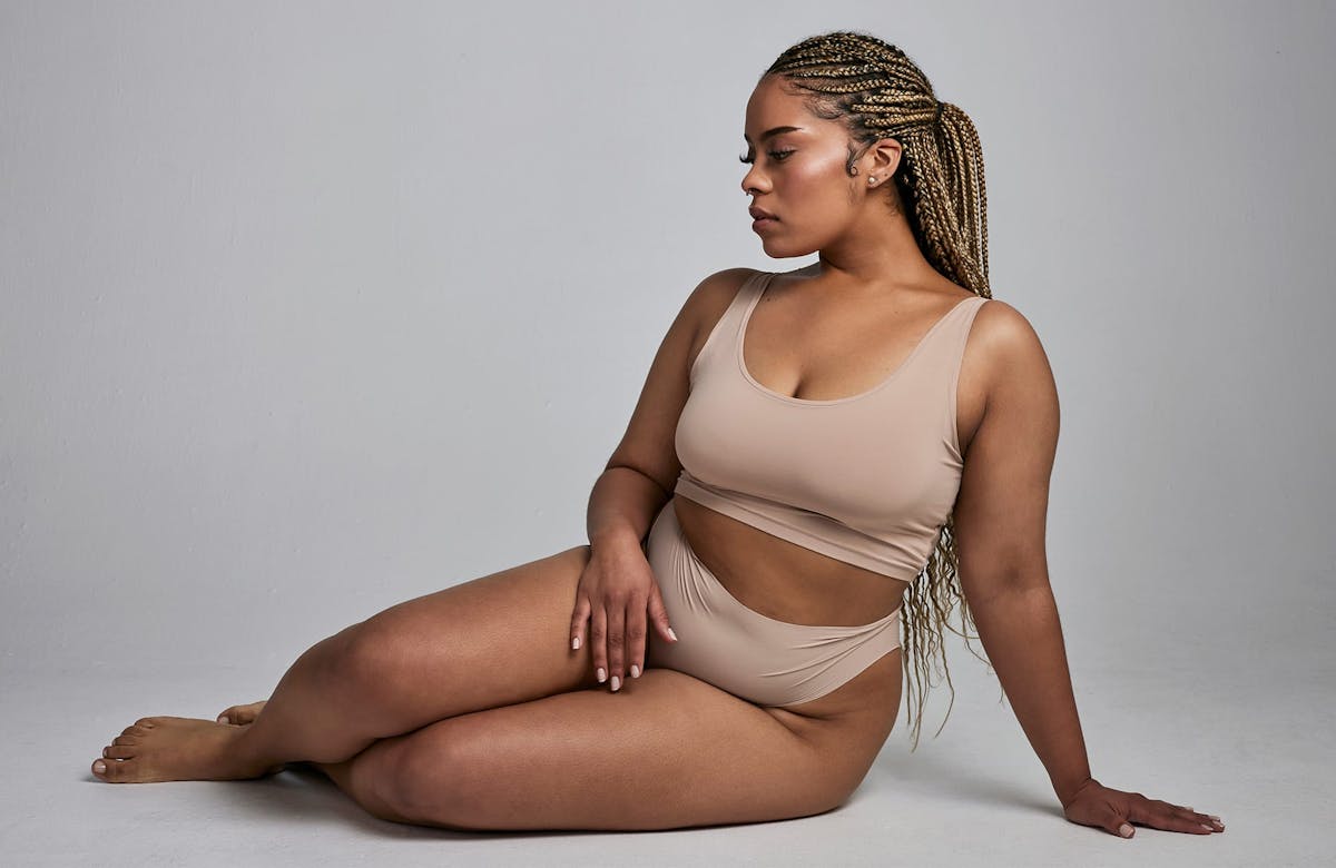 Woman posing in tan undergarments