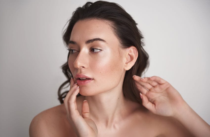 Woman touching cheek