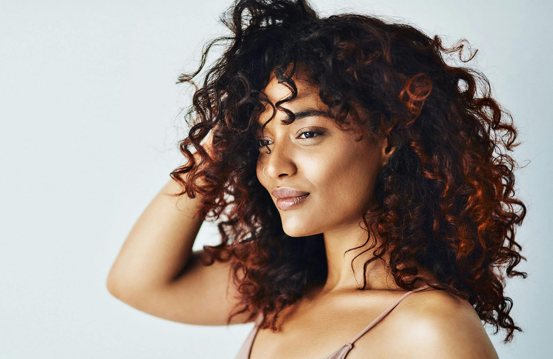woman smiling and runner hand through hair