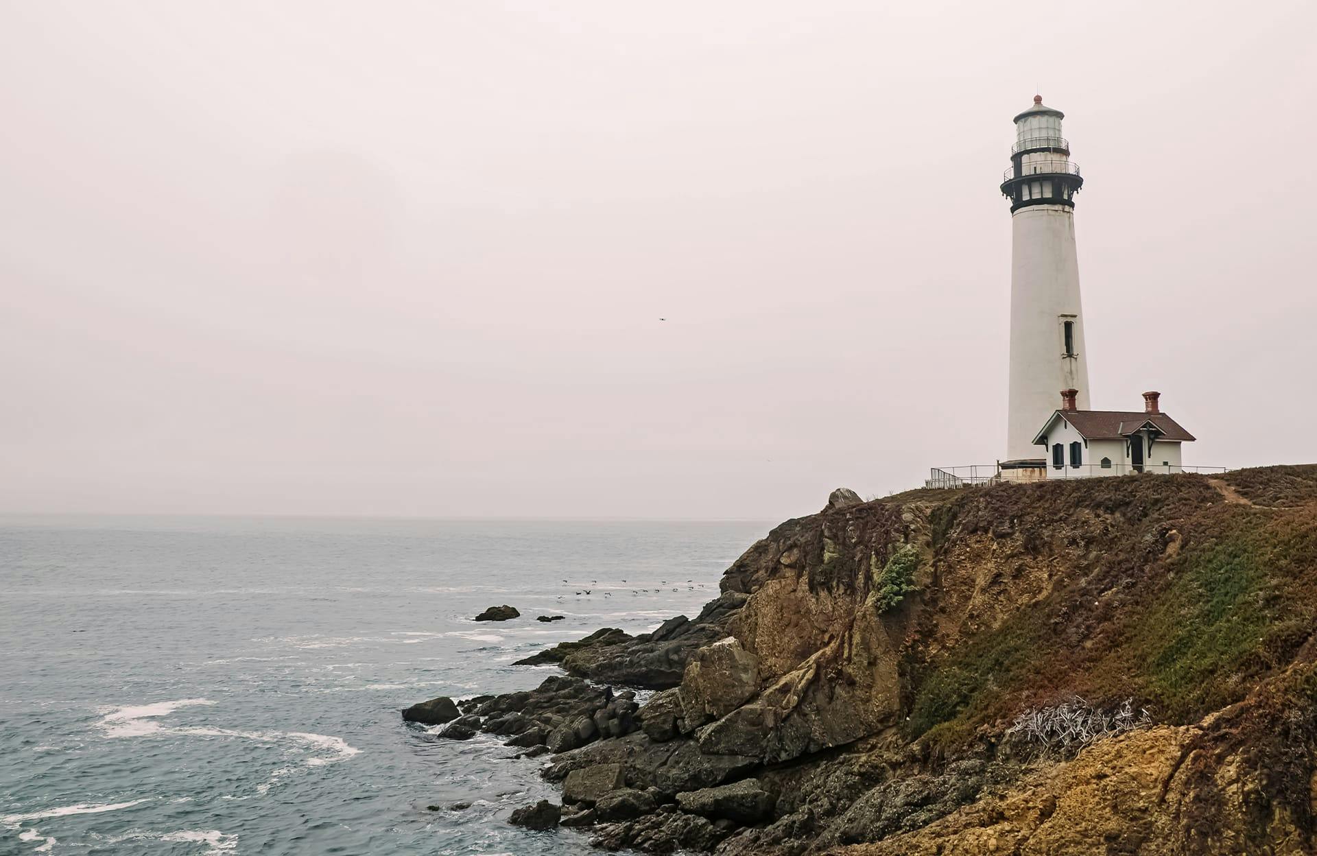 lighthouse next to ocean