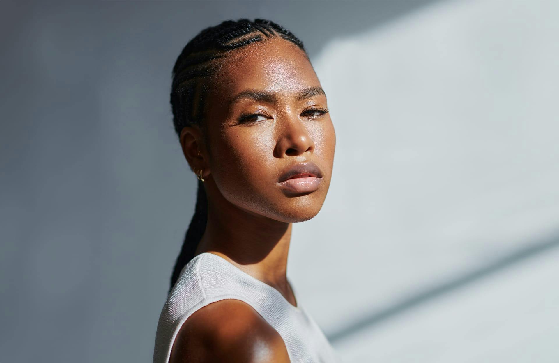 Dark-skinned woman in white top