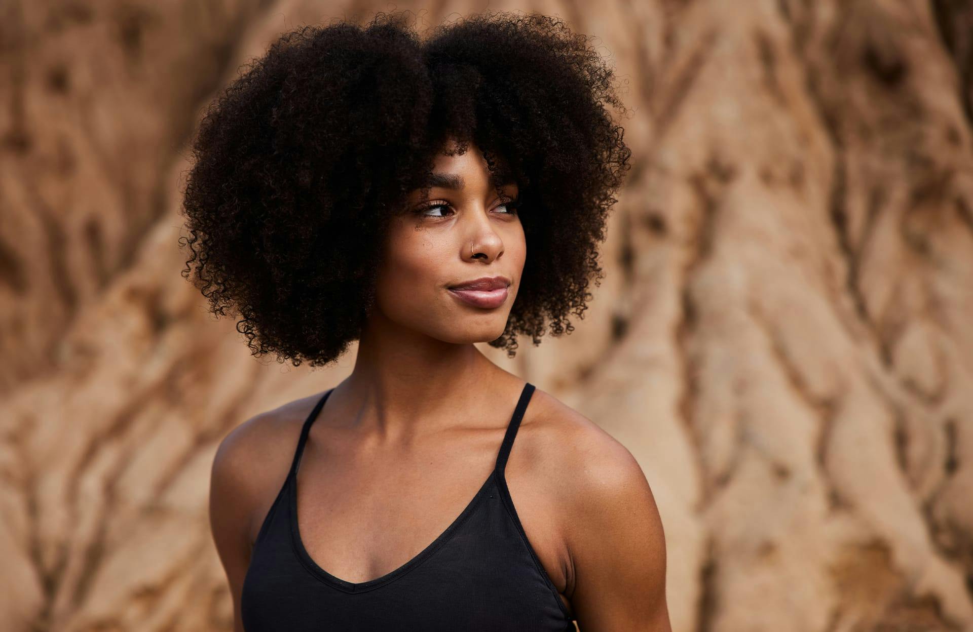 Curly-haired woman on the beach