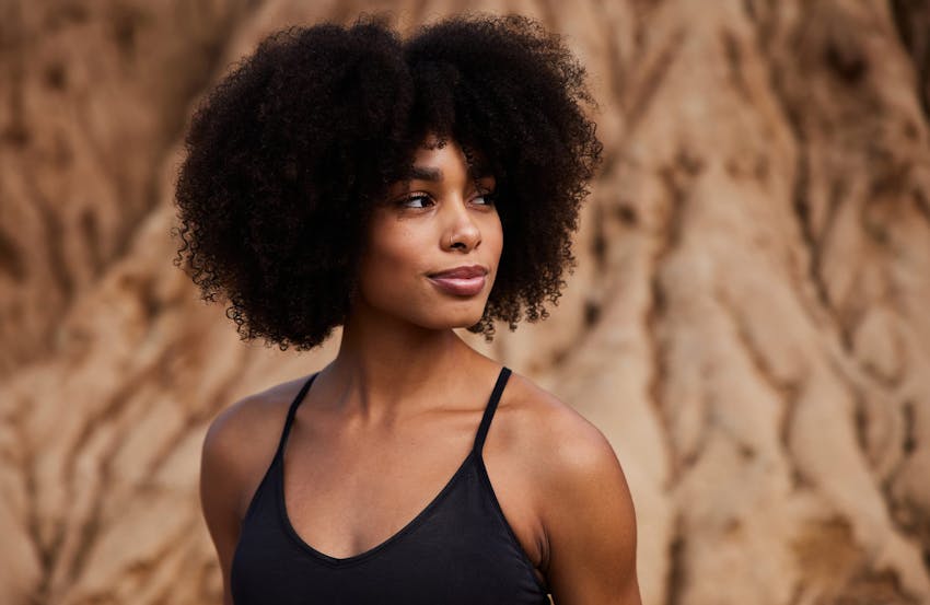Curly-haired woman on the beach