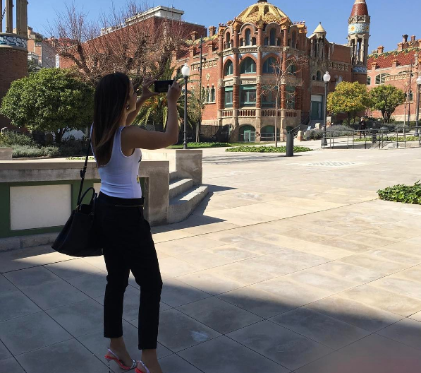 Woman taking a photo outside