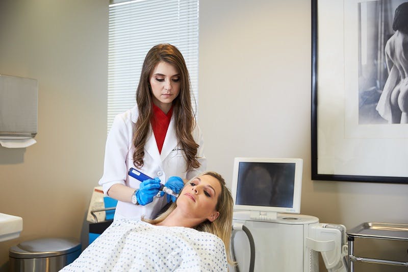 Woman recieving facial treatment