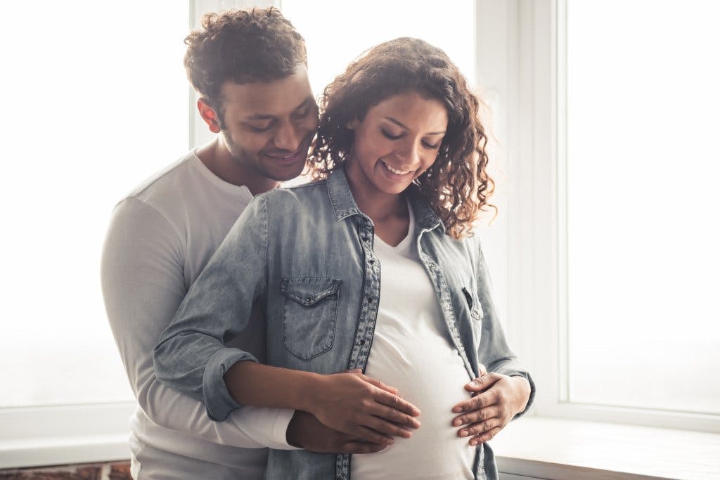 Man holding his pregnant wife's stomach