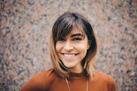 Woman in orange sweater