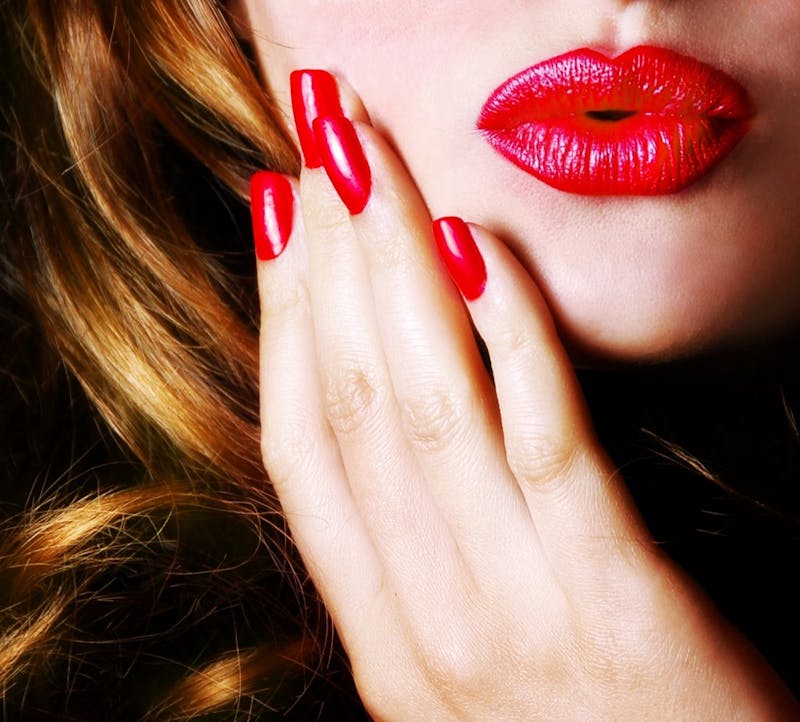 Woman with red nails and lipstick