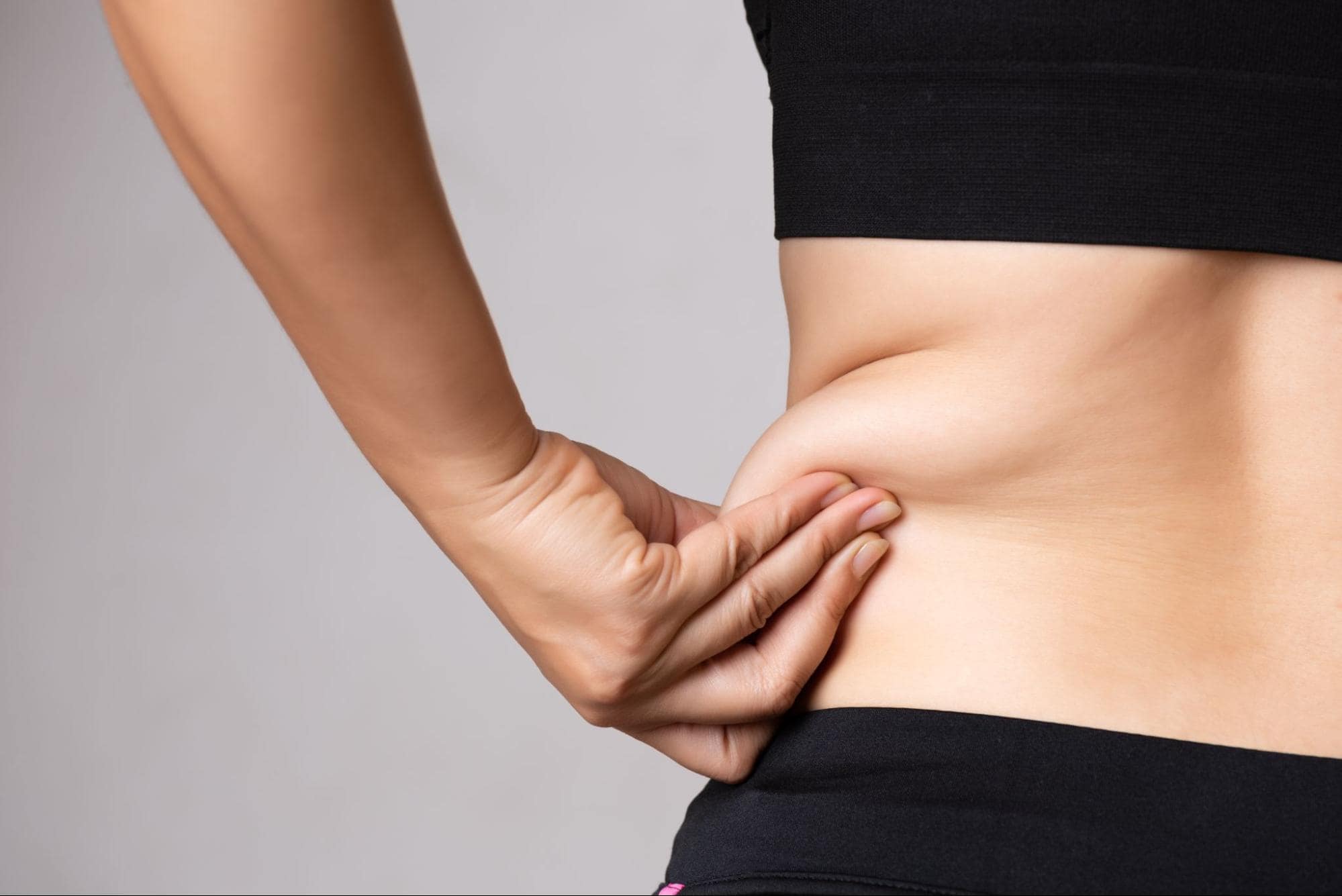 Woman touching her love handles