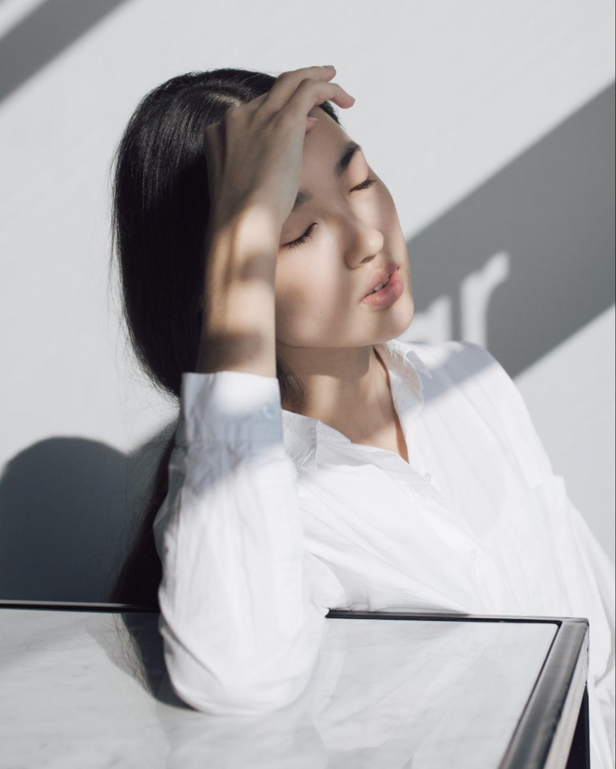 Woman touching her forehead