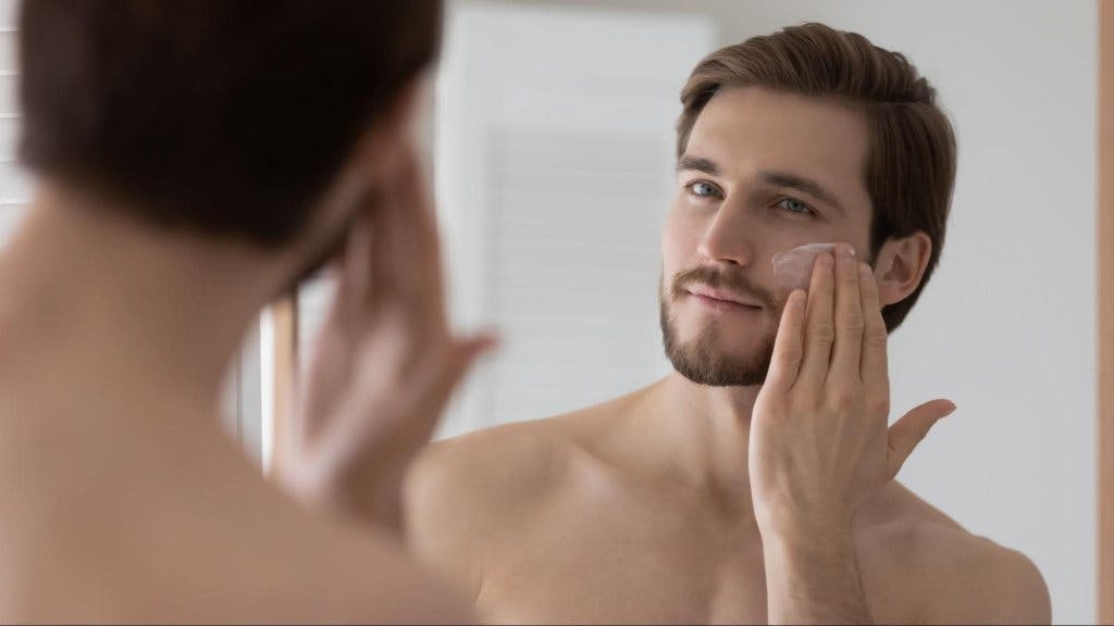 Man applying face product