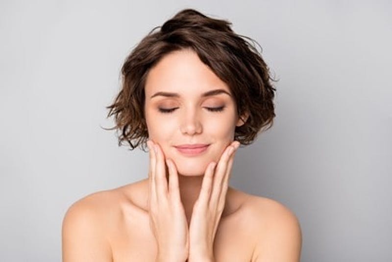 woman with very short curly brown hair