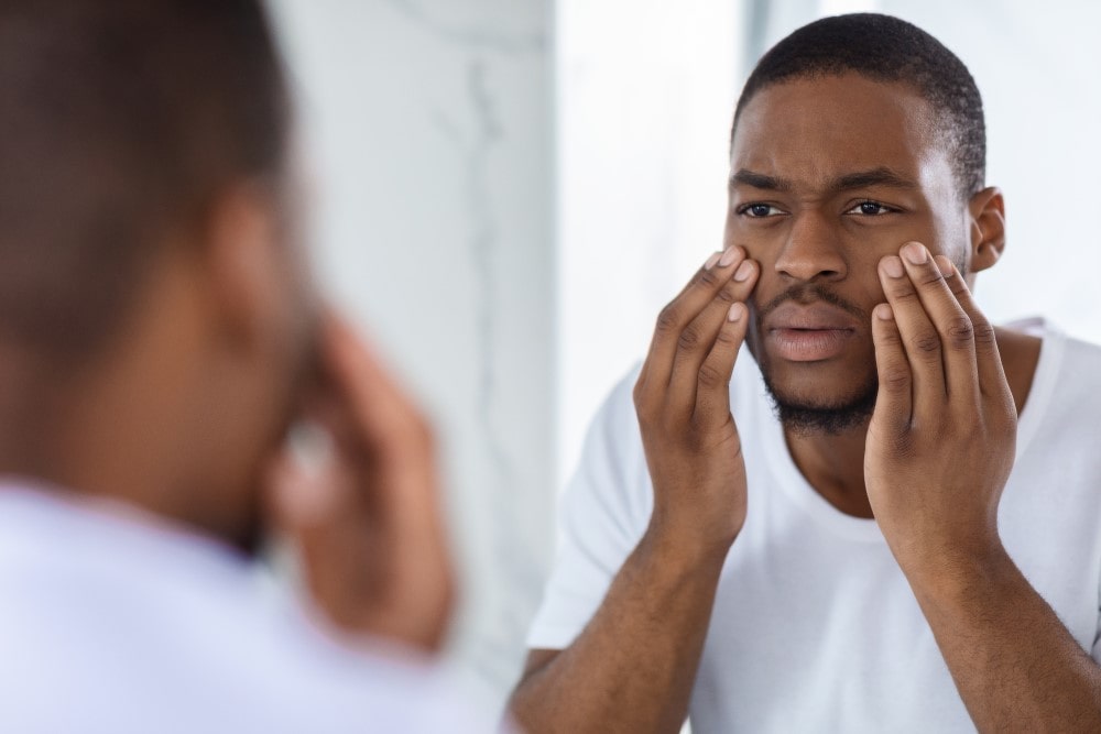 man looking at himself in a mirror
