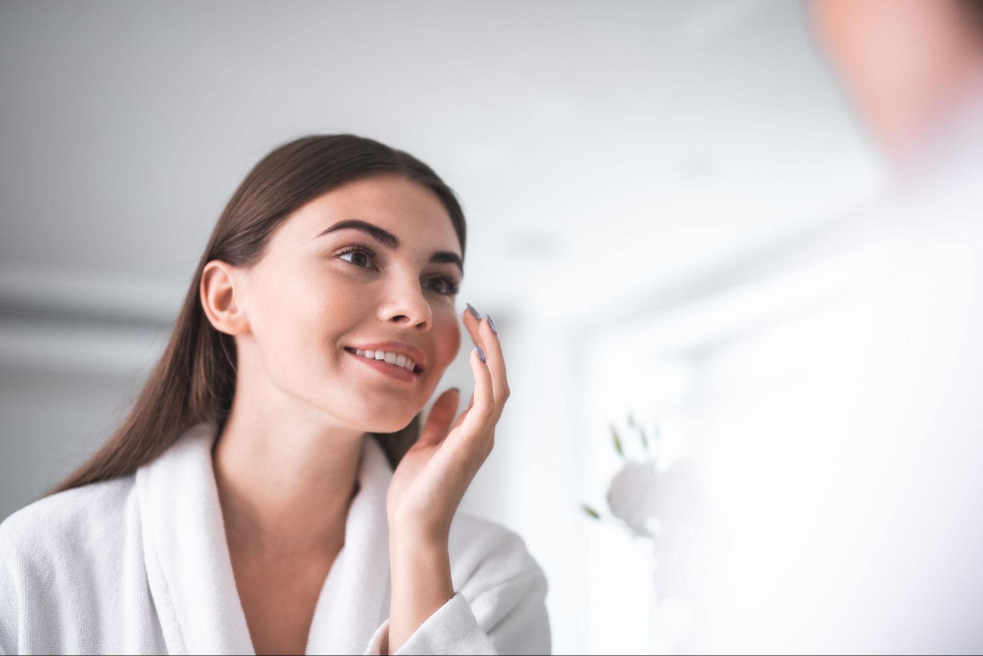 woman looking at herself in the mirror