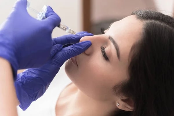 woman getting a liquid rhinoplasty procedure