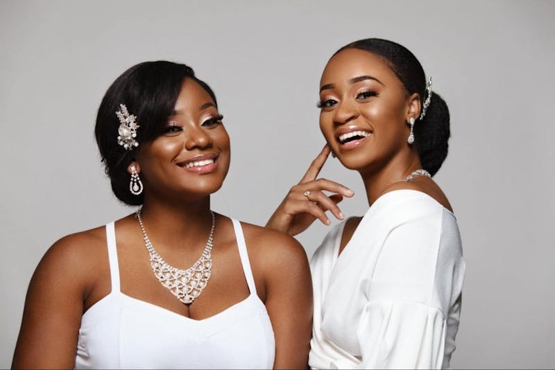 two women wearing white