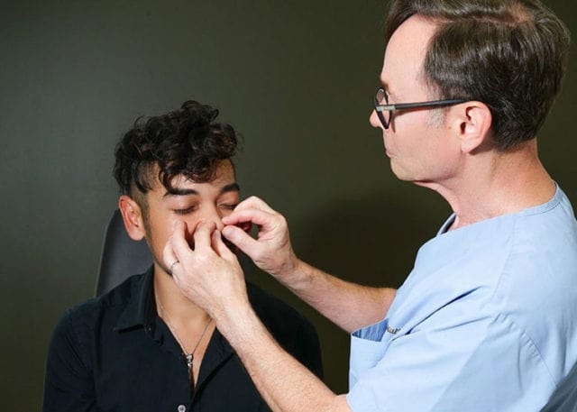 doctor inspecting a patient's nose