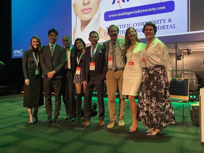 people posing for a photo at a conference