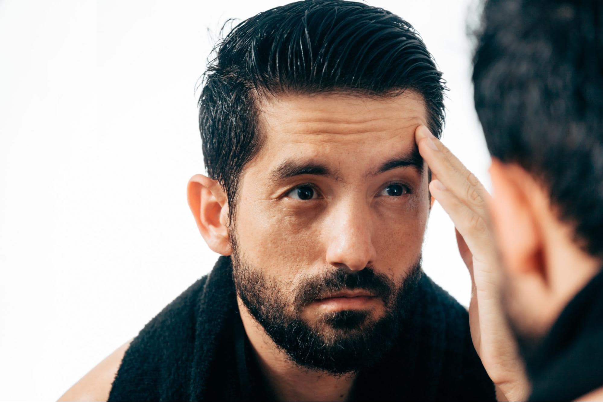 man touching his face