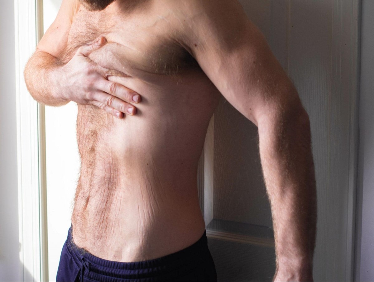 man grabbing his chest
