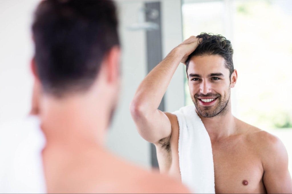 man running his hand through his hair