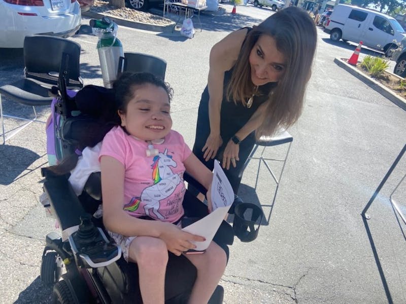 Doctor and young girl in a wheelchair