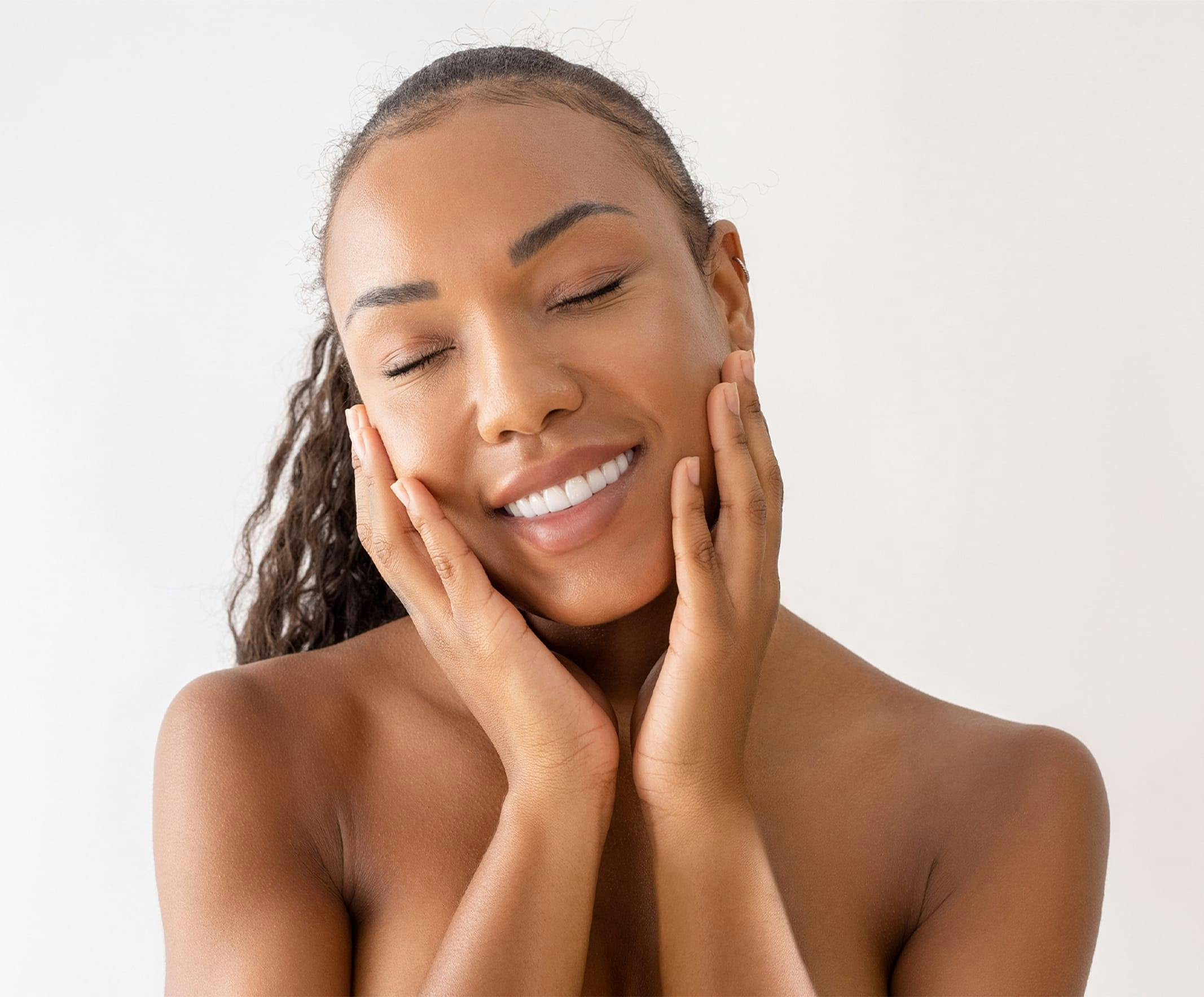 Woman touching cheek and smiling